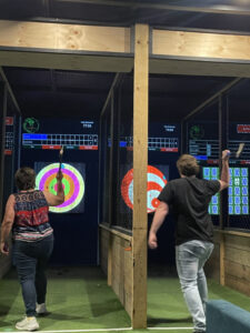 A picture of people enjoying an Axe Throwing competition